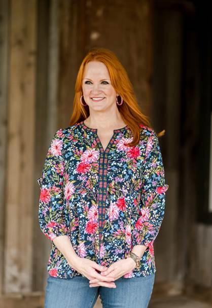 Ree Drummond standing in front of a building